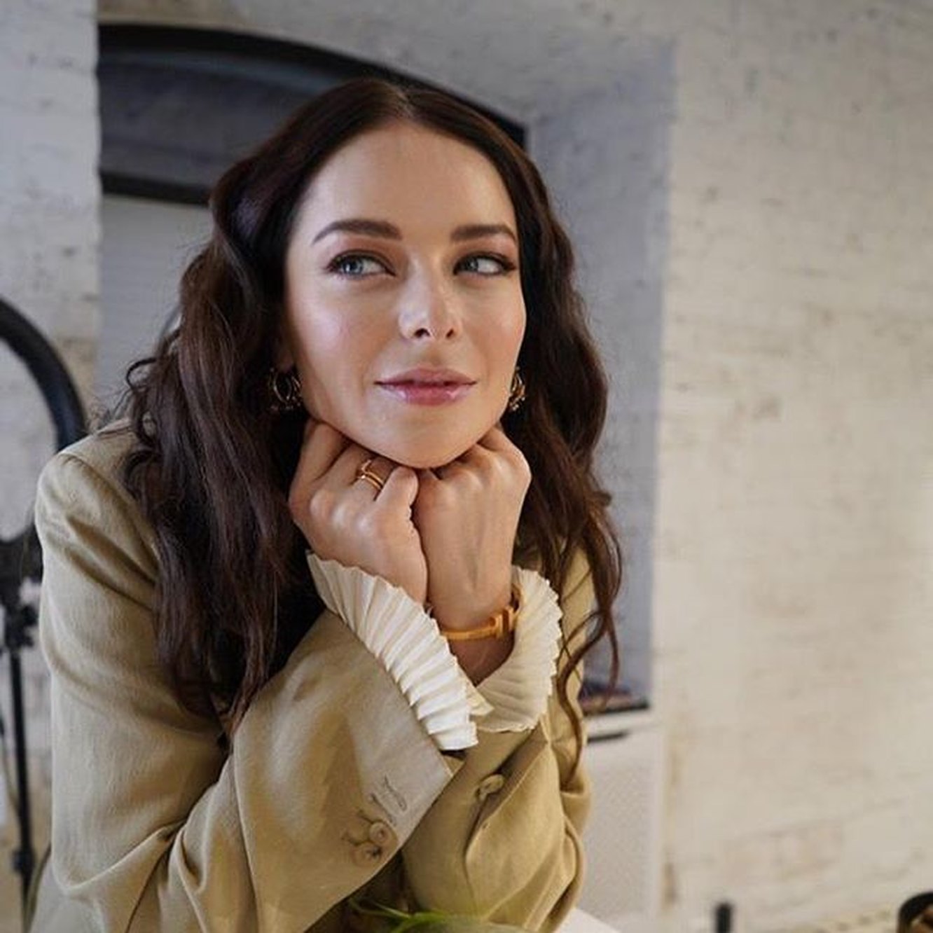 This is a square image with resolution 1332x1332, dominant color gray, approximately 2 main objects, containing 3 people.