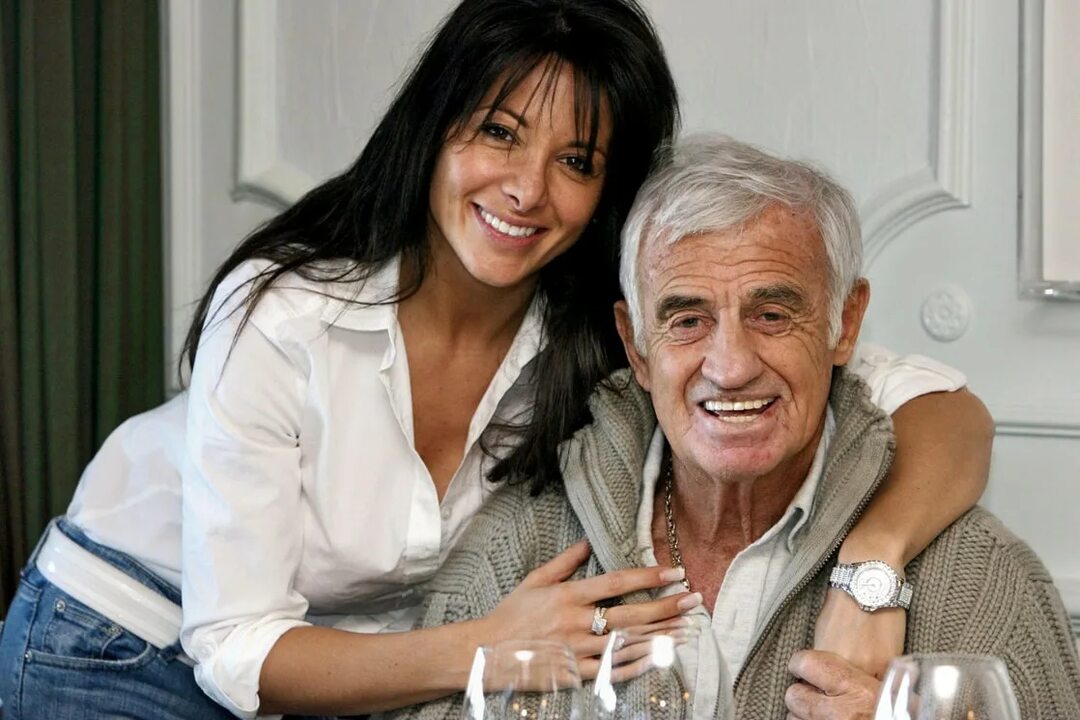 This is a landscape image with resolution 1080x720, dominant color gray, approximately 5 main objects, containing 2 people.