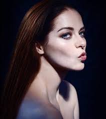 This is a portrait image with resolution 212x238, dominant color black, approximately 1 main objects, containing one person.